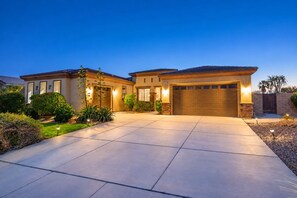 A two-story house with a large driveway and a garage. - Indio 5BR Desert Oasis, Sleeps 14, Private Saltwater Pool and Spa (Indio)