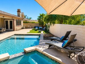A backyard with a swimming pool, lounge chairs, and a covered patio area. - Indio 4000 SQ FT 5bedroom. 3 BATH, SALT, POOL , SPA, WiFi and AC, COACHELLA, (Indio)