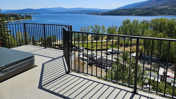 A balcony with a view of a lake and mountains.