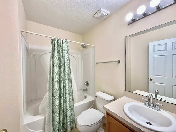 A bathroom with a shower, toilet, and sink. - Magic Oasis Retreat (Davenport)