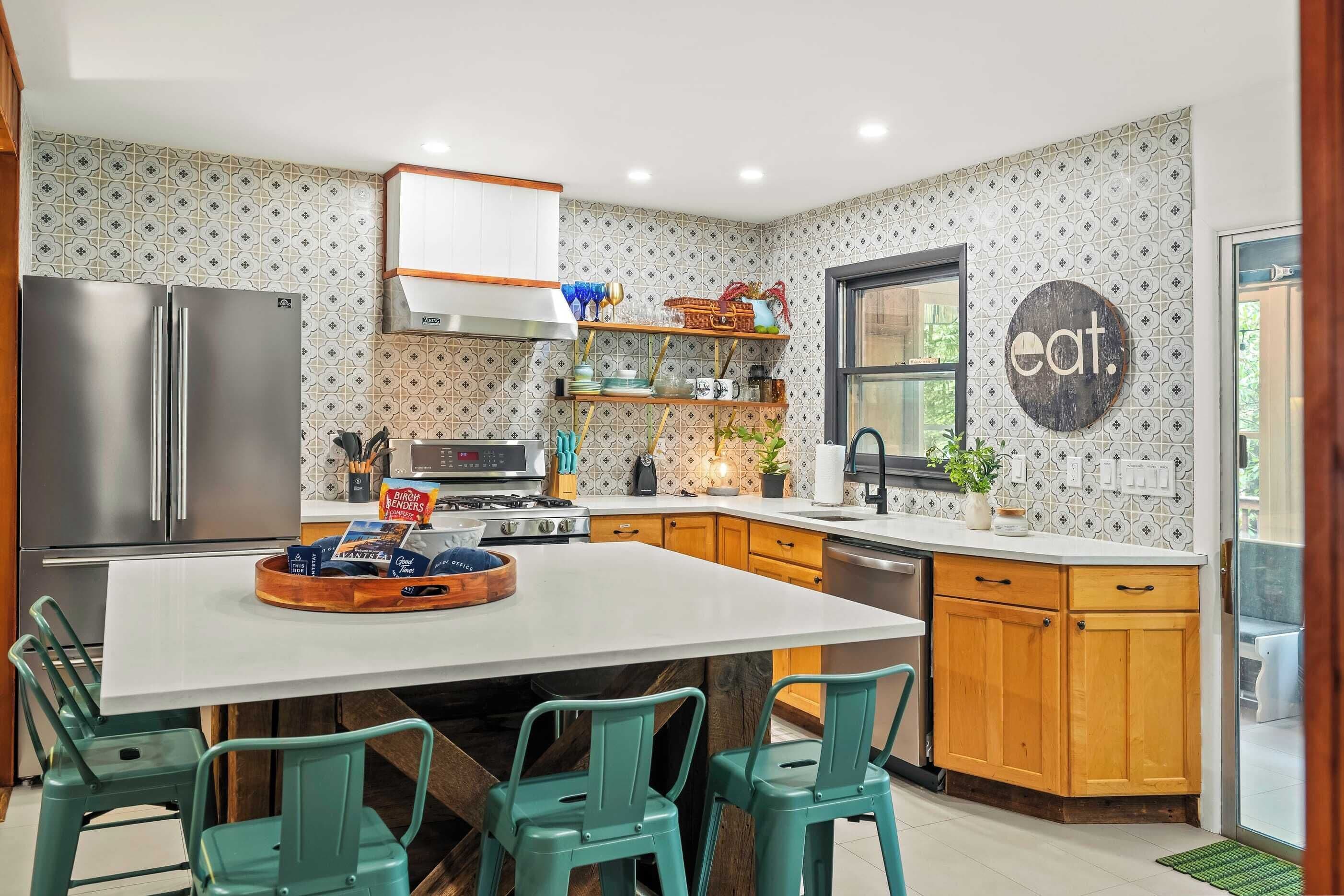 A modern kitchen with a central island, wooden cabinets, and a backsplash with a geometric pattern.