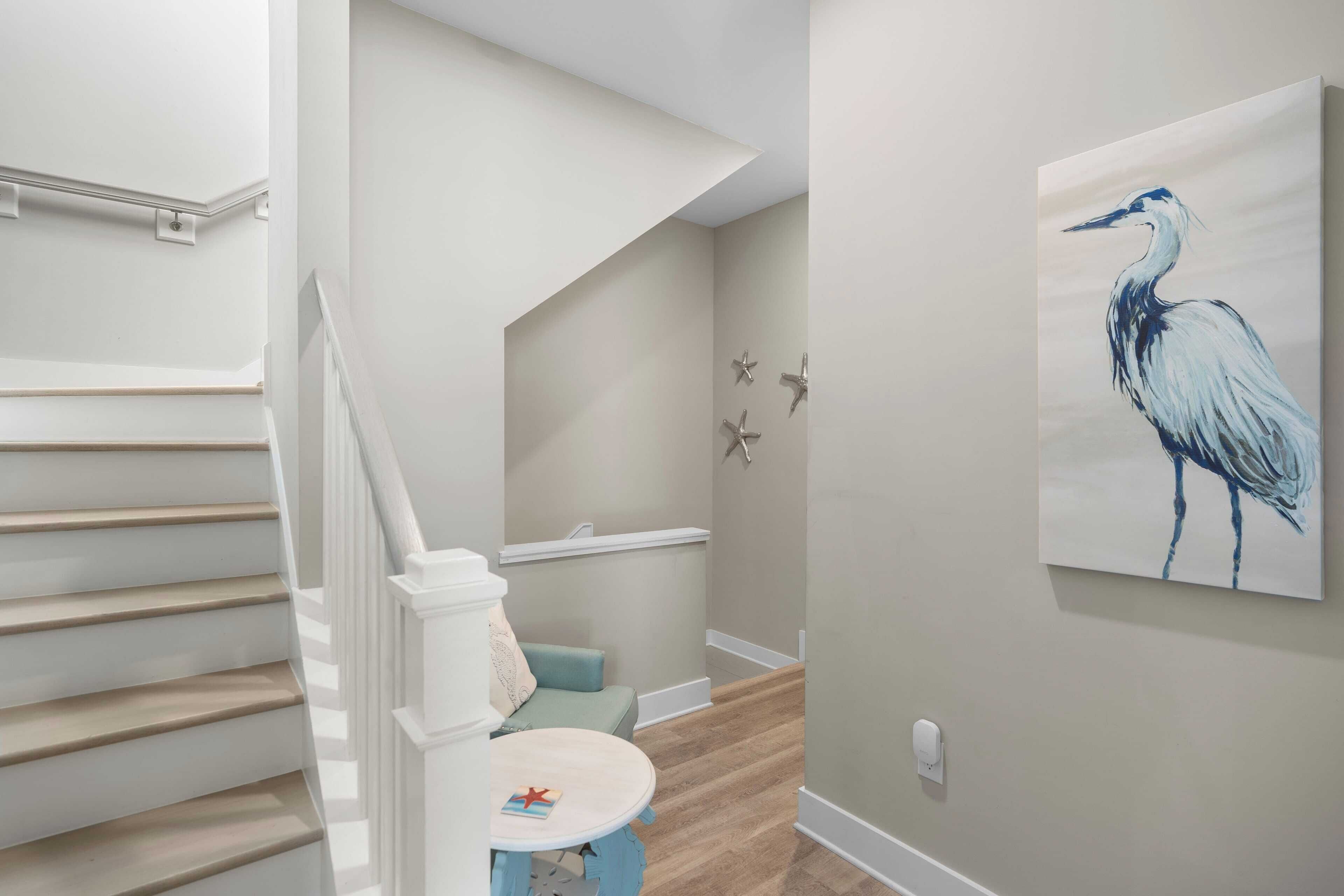 A staircase with white railings and a light blue wall.