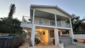 A two-story house with a balcony, a covered porch, and a garage. - 3/2 waterfront home w/54ft dock with WiFi, AC in wonderful Summerland Key (Summerland Key)