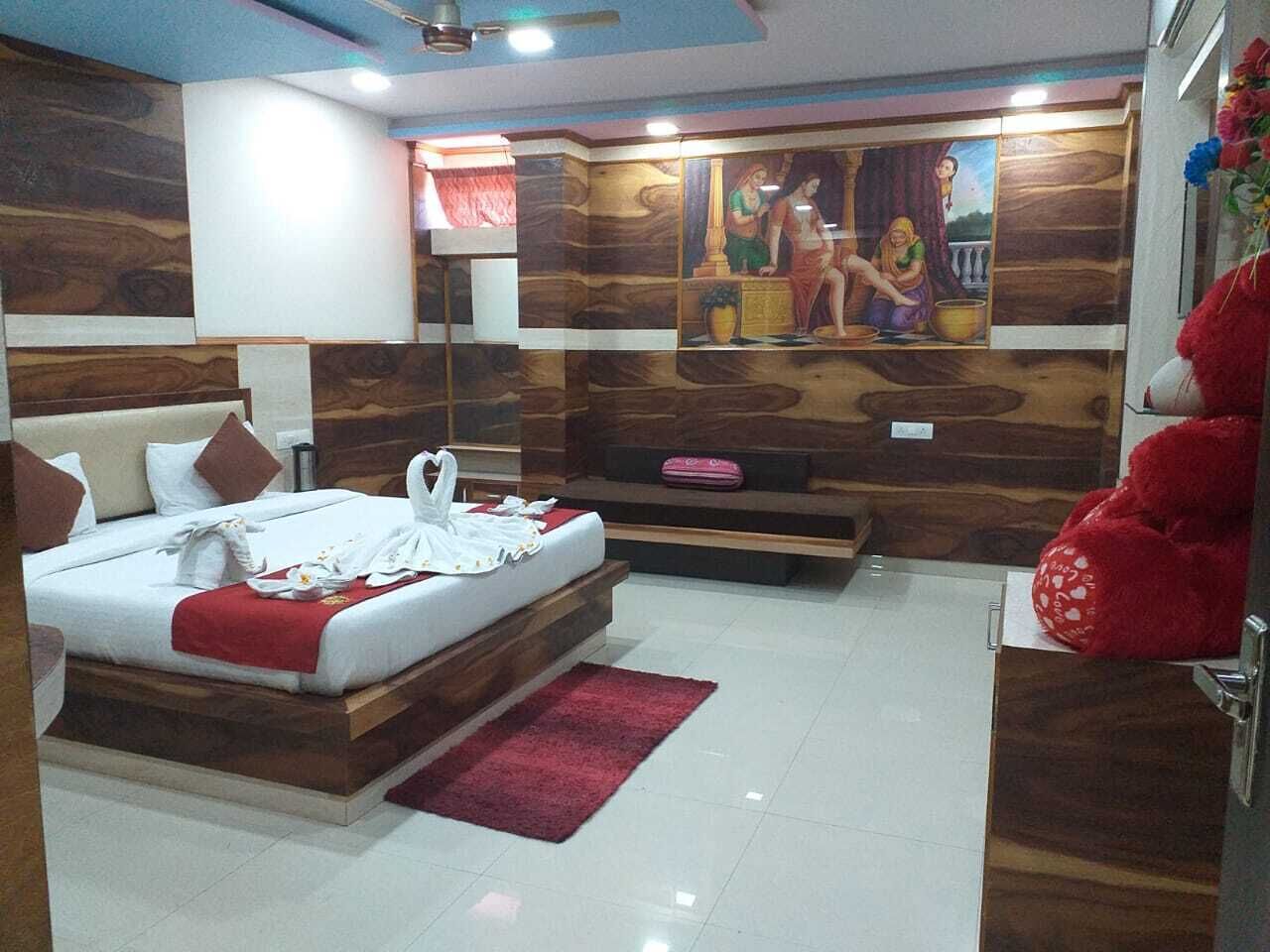 A bedroom with a bed, a red rug, a wooden wall with a mural, and a red teddy bear.
