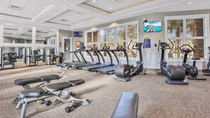 A gym with treadmills, elliptical machines, and weight benches. - Sun-soaked At Solterra (Davenport)