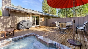 A wooden deck with a hot tub, outdoor furniture, and a barbecue grill. - 6 Dutchman - Light, Bright, Lovely, Enclosed Deck, Hot Tub, SHARC (Bend)