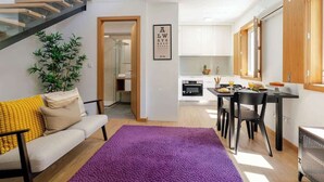 A modern apartment with a living area, a dining space, and a kitchen. - Stylish Duplex w/ Garage by HostWise (Porto)