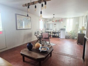 Cozy living area with a coffee table, dining space, and kitchen.