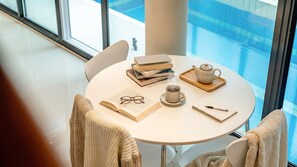 A round table with books, a teapot, a cup, glasses, and a notebook. - Mungyeong The Most Pool Villa (Mungyeong)