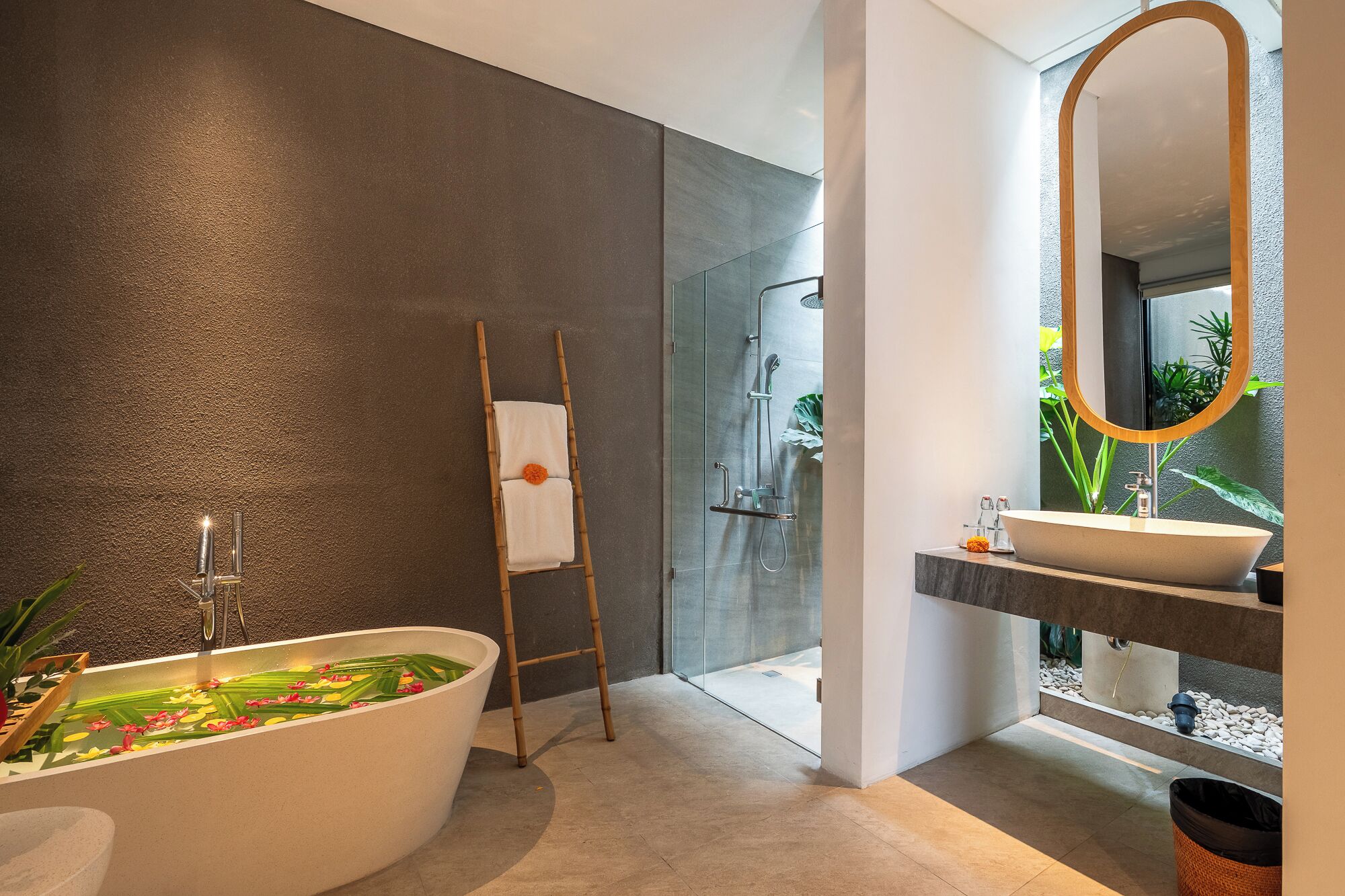 A modern bathroom with a freestanding bathtub, a glass shower enclosure, and a large mirror.