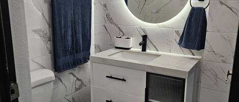 Secadora de cabello, toallas, jabón, papel de baño