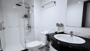 A modern bathroom with a glass-enclosed shower, a white toilet, and a black sink with a large mirror above it. - Beautiful Hotel Bui Vien (Ho Chi Minh City)