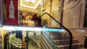 A hotel lobby with a staircase, a reception desk, and a spa area. - Beautiful Hotel Bui Vien (Ho Chi Minh City)