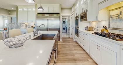 Luxurious beach house with outdoor dining and elegant design - steps to beach