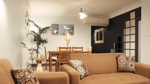A living room with a brown sofa set, a dining table with chairs, and a large potted plant. -  NOUR1
Sea view (Alexandria)