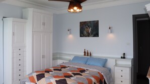 A bedroom with a bed, a ceiling fan, a nightstand, and a wardrobe. -  NOUR1
Sea view (Alexandria)