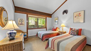 A bedroom with two beds, a large window, and a mirror. - 2 bed/ 2 bath single story condo in the heart of Graeagle Meadows (Graeagle)