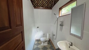 A small bathroom with a toilet, sink, and shower. - Green Lake Bali (Kintamani)