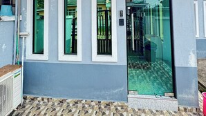 A small building with a tiled roof, a glass door, and a tiled floor. - Darul Salam Inn (Kerteh)