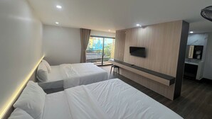 A hotel room with two beds, a TV, a desk, and a balcony with a view. - Thao Trang Luxury Hotel Dong Hoi (Dong Hoi)