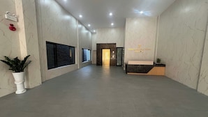 A hotel reception area with marble walls, a reception desk, and an elevator. - Thao Trang Luxury Hotel Dong Hoi (Dong Hoi)