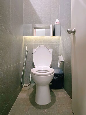 A modern bathroom with a toilet, a shower, and a towel rack. - Hlangkha Hostel (Betong)