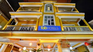 A multi-story building with a prominent 'Tab Hotels' sign on the second floor.