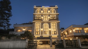 A hotel with a modern facade, multiple balconies, and a well-lit entrance. - Fabhotel Nfc Royale (New Delhi)