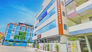 A hotel with a modern facade, multiple floors, and a prominent sign for 'FOP Hotels'. - Fabhotel arjun residency - Near Kazipet junction railway station (Hanmakonda)