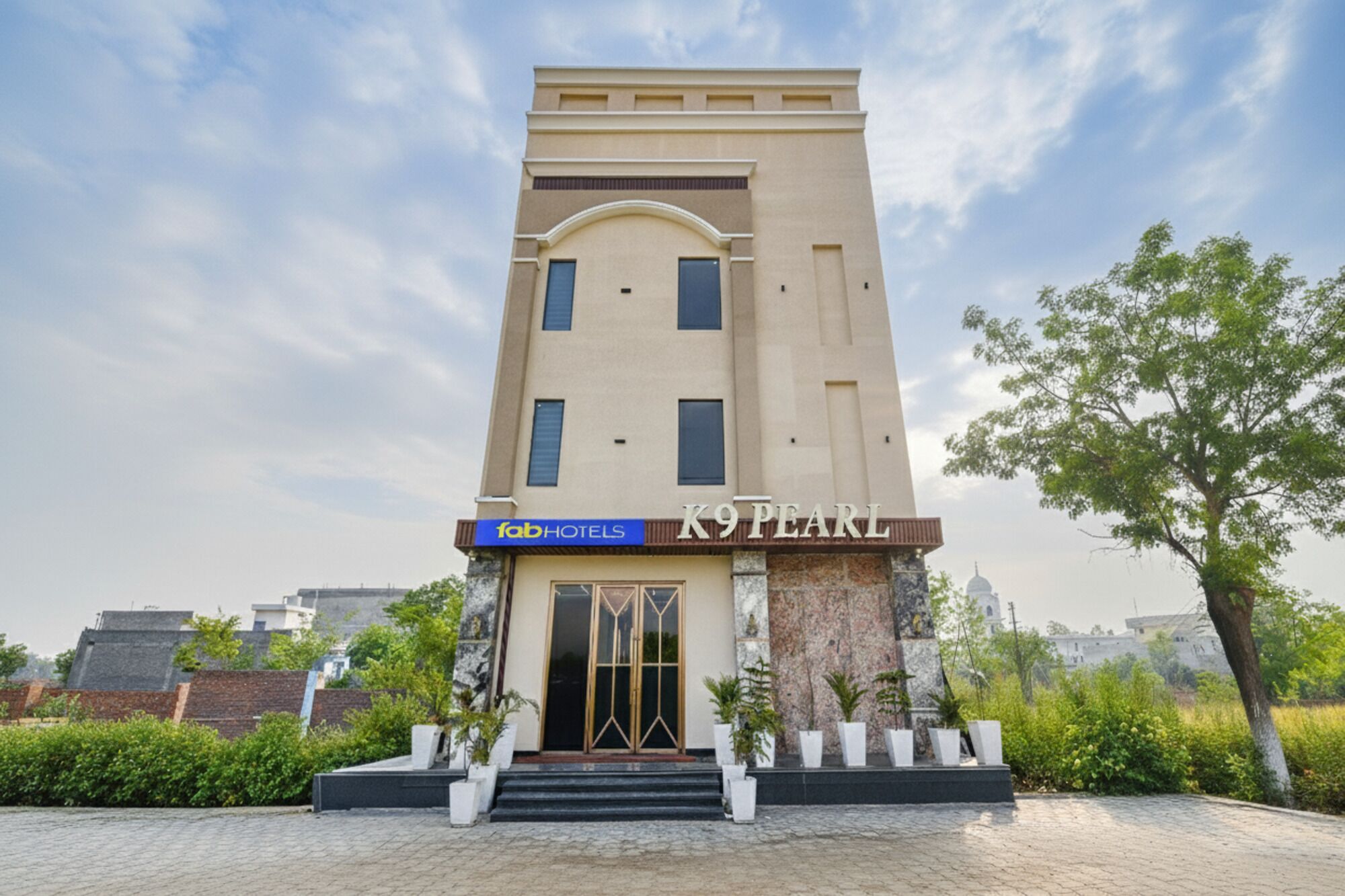 A modern hotel with a prominent entrance and a sign for 'fab hotels'.