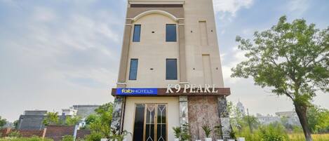 A modern hotel with a prominent entrance and a sign for 'fab hotels'.