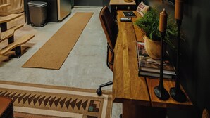 A modern kitchen with a built-in refrigerator, wooden cabinets, and a dining area with a wooden table and chairs. - Modern Mountain Mini House- studio house w/ sleeping loft Packwood with WIFI, AC (Packwood)
