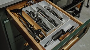 A kitchen with a drawer containing various utensils, a toaster oven, and a shelf with containers. - Modern Mountain Mini House- studio house w/ sleeping loft Packwood with WIFI, AC (Packwood)