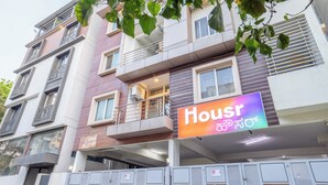 A multi-story building with a sign reading "Housr" and balconies.