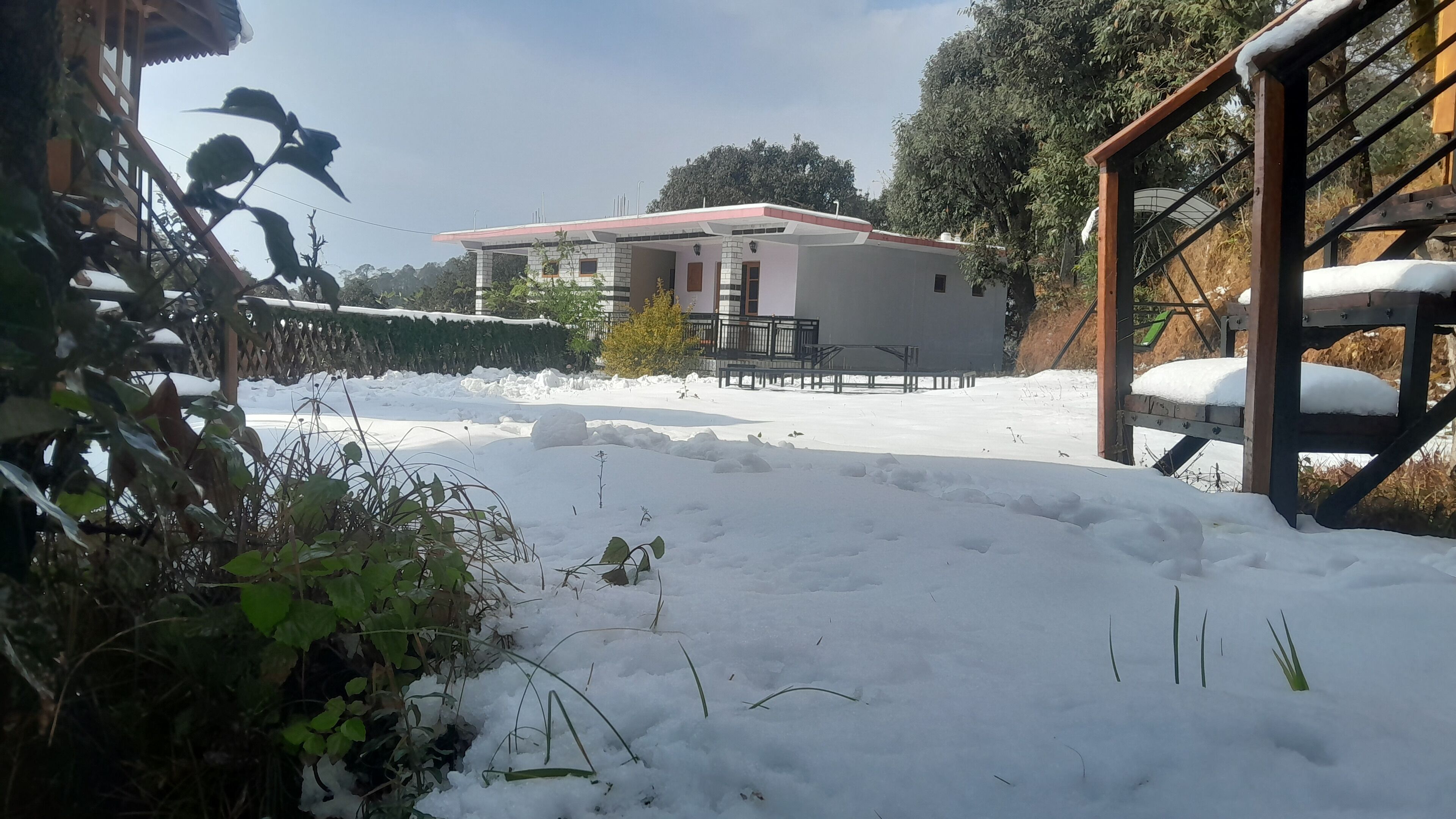 A snow-covered outdoor area with a building in the background.
