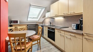 A compact kitchen with a dining area, a microwave, a toaster, and a window. - Farmhouse 'Zur Henne' with Shared Terrace and Wi-Fi (Weinbach)