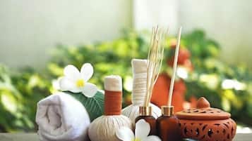 A table with a rolled towel, a white flower, a white flower, a brown bottle, a brown bottle, a brown bottle, a brown bottle, a brown bottle, a brown bottle, a brown bottle, a brown bottle, a brown bottle, a brown bottle, a brown bottle, a brown bottle, a brown bottle, a brown bottle, a brown bottle, a brown bottle, a brown bottle, a brown bottle, a brown bottle, a brown bottle, a brown bottle, a brown bottle, a brown bottle, a brown bottle, a brown bottle, a brown bottle, a brown bottle, a brown bottle, a brown bottle, a brown bottle, a brown bottle, a brown bottle, a brown bottle, a brown bottle, a brown bottle, a brown bottle, a brown bottle, a brown bottle, a brown bottle, a brown bottle, a brown bottle, a brown bottle, a brown bottle, a brown bottle, a brown bottle, a brown