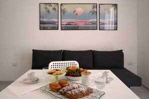 Relax in a comfortable seating area with a sofa and enjoy a meal at the dining table.