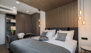A modern bedroom with a large bed, bedside tables, a desk, and a chair. - Villa Grancarić Zadarvillas (Zadar)
