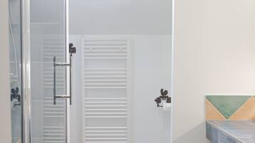 Une salle de bain avec un puits de lumière, une douche et des toilettes.