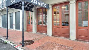 A building with a black awning displaying the number 333 and the name GIROD. - Chic 1BR in Warehouse District with. King bed, exposed brick, walk to FQ (New Orleans)