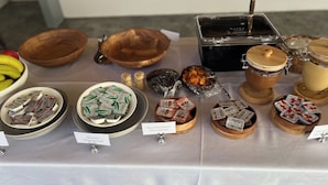 A table with various food items and containers, including bowls, jars, and packets labeled with product names.