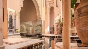 A luxurious interior with marble flooring, ornate arches, and a reflective glass wall. - Riad Mayan & Spa (Marrakech)