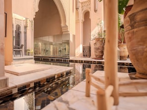 A luxurious interior with marble flooring, ornate arches, and a reflective glass wall. - Riad Mayan & Spa (Marrakech)