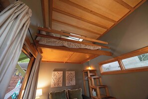 A room with a bunk bed, wooden beams, a ladder, a window, and wall art. - Walk to the Beach & Famous Sunset Cliffs | Hot Tub (San Diego)