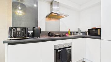 Apartment | Private kitchen | Full-size fridge, microwave, oven, stovetop
