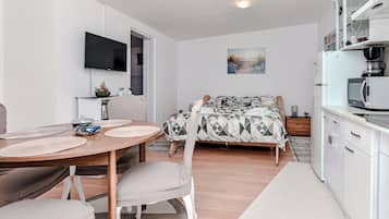 Basic Apartment, Garden View | Living area | 100-cm LCD TV with digital channels