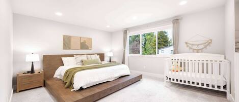 A bedroom with a bed, nightstand, crib, and a window with a view of trees.