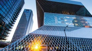 A modern building with a geometric facade and a prominent glass structure. - Luxury Bellevue 2B Basement w/ 180º+ Stunning View (Bellevue)