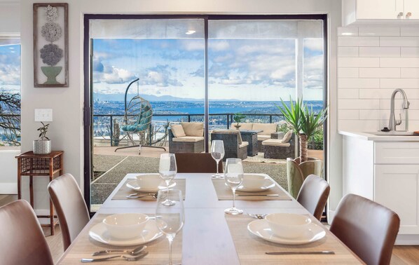 Enjoy meals in this cozy dining nook next to the sliding glass doors,leading to a spacious deck with breathtaking views-perfect for morning coffee and meals.
